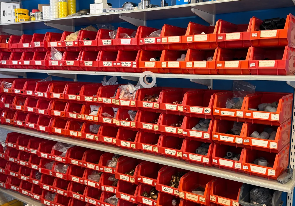 Labelled plumbing fittings arranged on the shelves at Sowdens