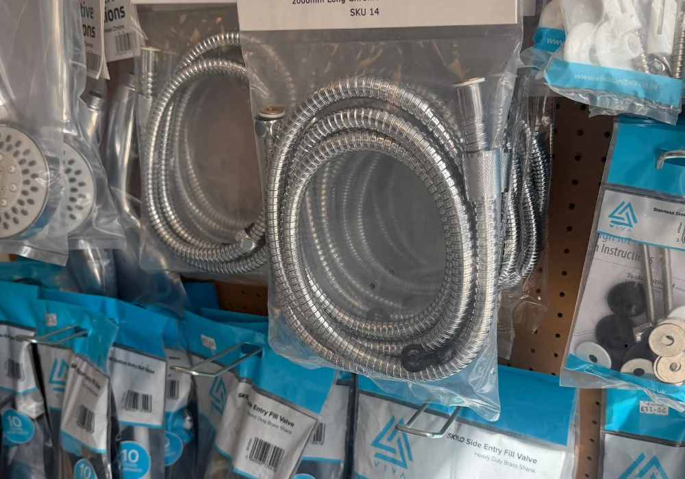 Shower hoses and plumbing fittings on display in the shop